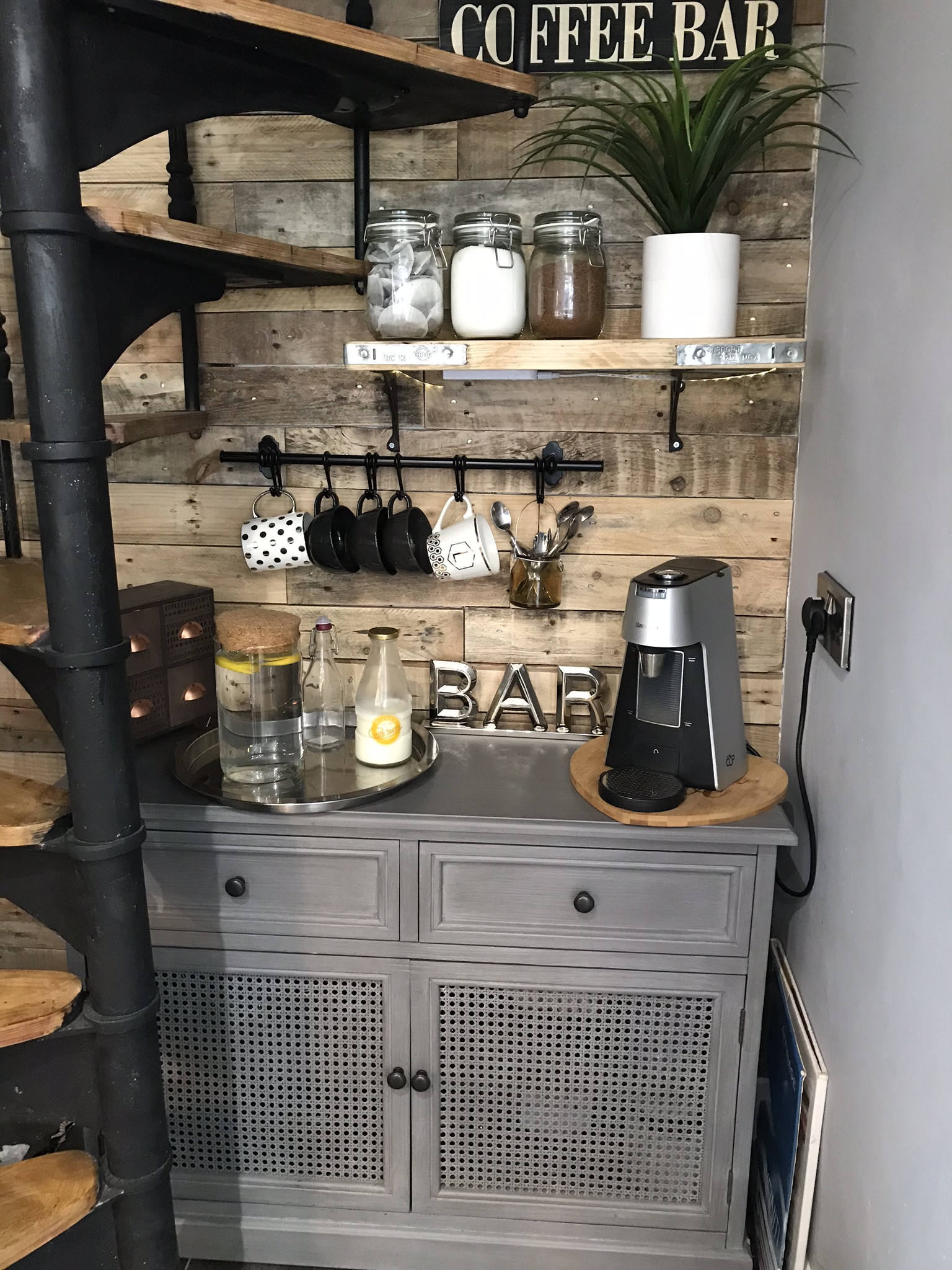 The spiral staircase beside our coffee bar, against a reclaimed wood wall
