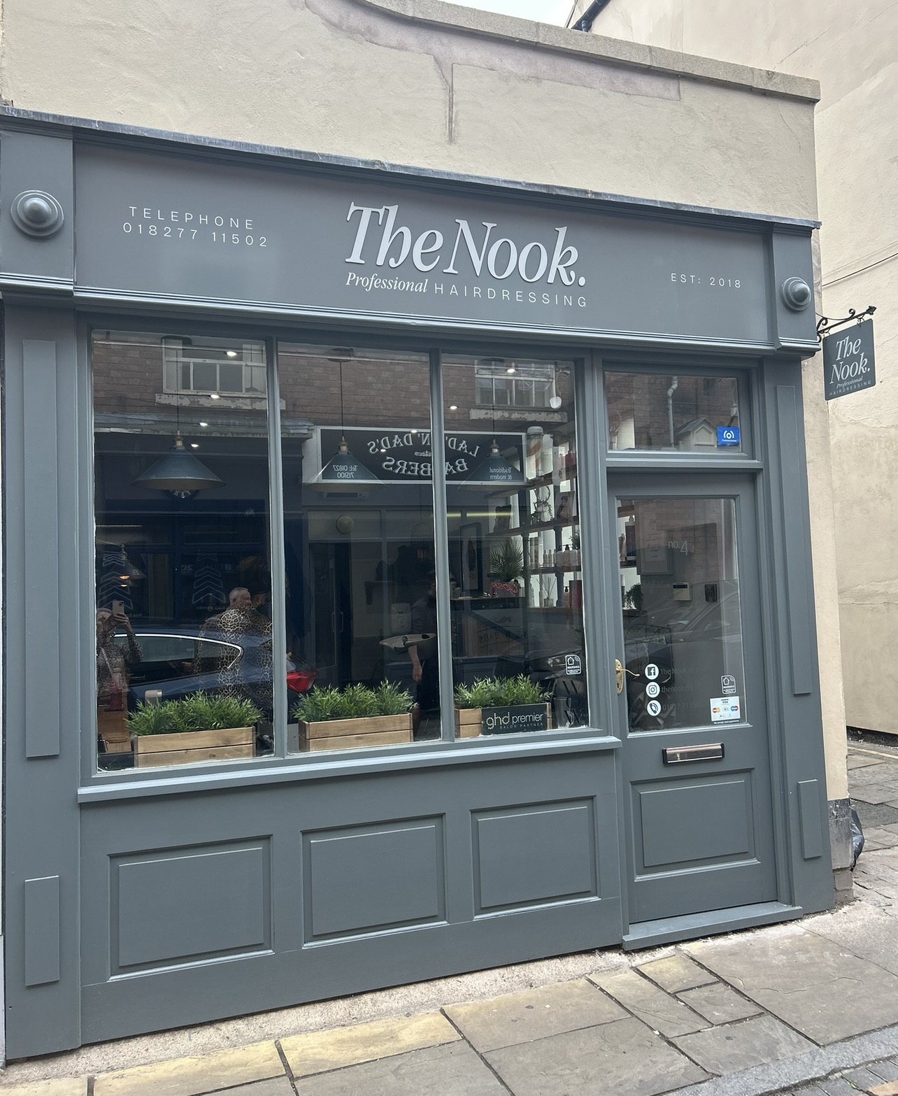 The Nook shopfront on Market Street, Atherstone, painted slate grey with the sign over the window